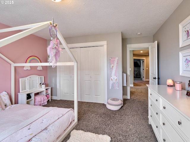 bedroom featuring baseboards, a closet, dark carpet, and a textured ceiling