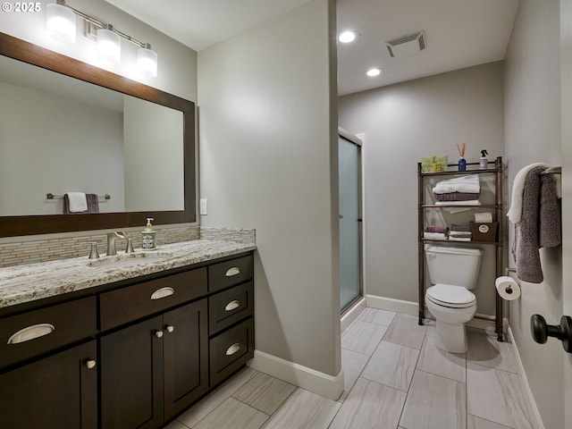 full bath featuring vanity, visible vents, toilet, baseboards, and a stall shower