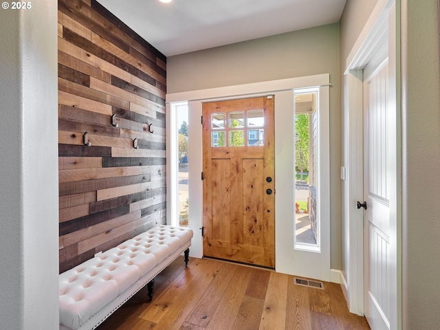 foyer entrance featuring visible vents and wood finished floors