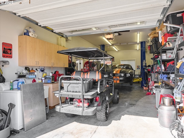 garage featuring washer / dryer and a garage door opener