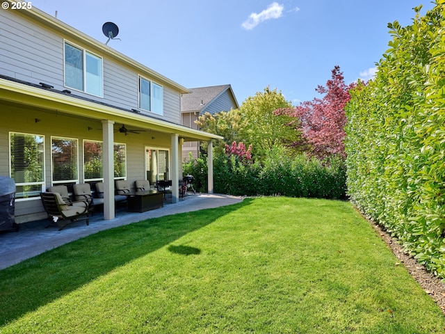 view of yard with a patio, ceiling fan, and outdoor lounge area