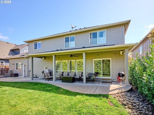 rear view of property featuring an outdoor hangout area, a ceiling fan, a patio, and a lawn