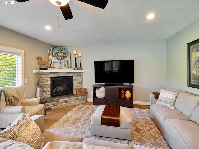 living room with a ceiling fan, recessed lighting, and wood finished floors