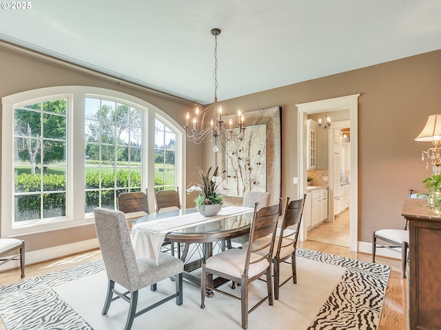 dining room with an inviting chandelier and light wood-type flooring