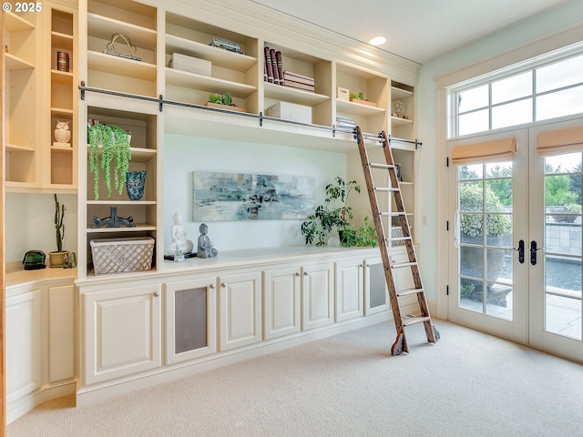 interior space with light carpet and french doors