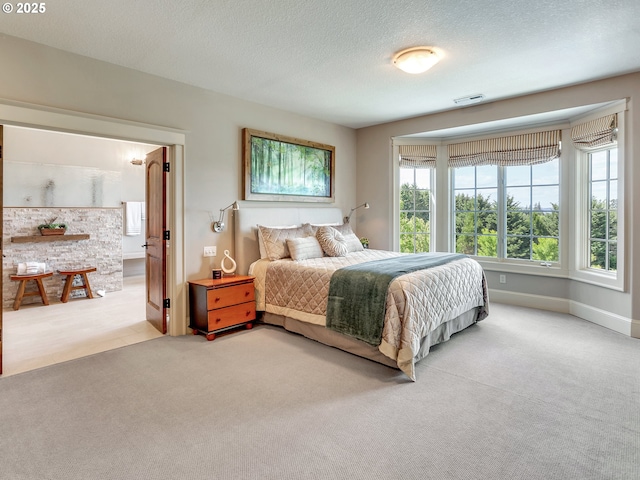 bedroom featuring light colored carpet and a textured ceiling