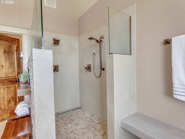 bathroom with tiled shower