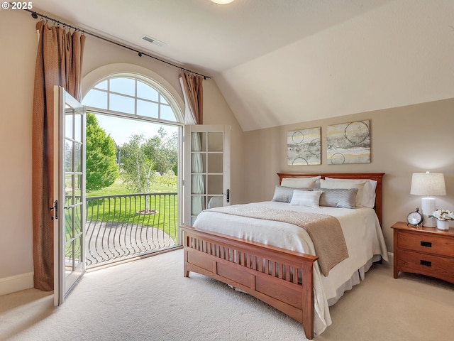 carpeted bedroom featuring lofted ceiling and access to outside