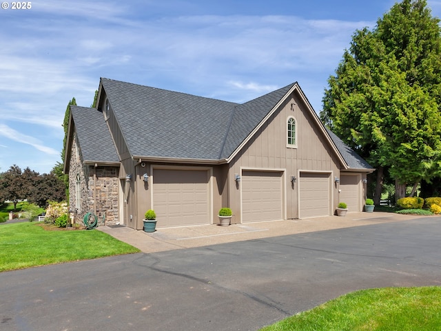 view of front of home with a garage and a front lawn