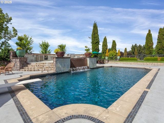 view of pool with pool water feature and a patio area