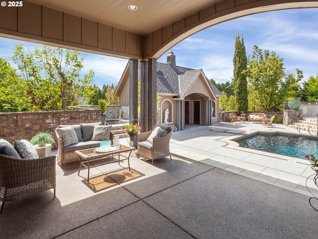 view of patio featuring a swimming pool with hot tub and an outdoor hangout area