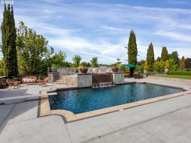 view of pool featuring pool water feature and a patio