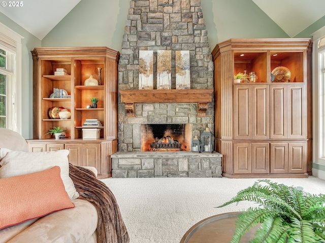 carpeted living room with a fireplace and vaulted ceiling