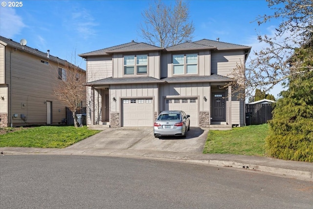 view of front of house with a front yard, concrete driveway, stone siding, a garage, and board and batten siding