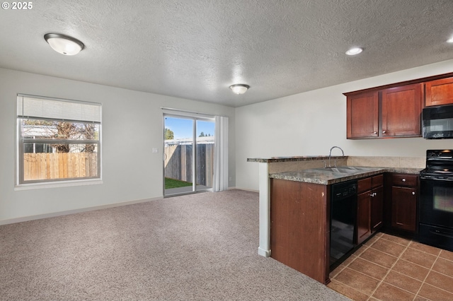 kitchen featuring open floor plan, dark carpet, a peninsula, black appliances, and a sink