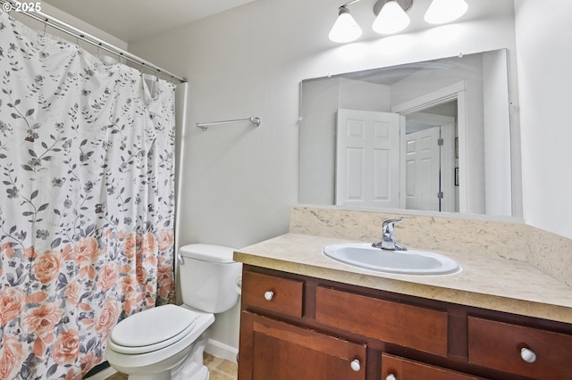 bathroom featuring toilet, vanity, and a shower with curtain