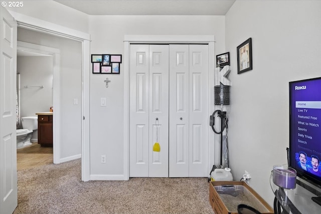 interior space with baseboards and carpet