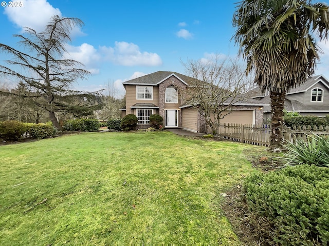 traditional home featuring an attached garage, brick siding, a front yard, and fence