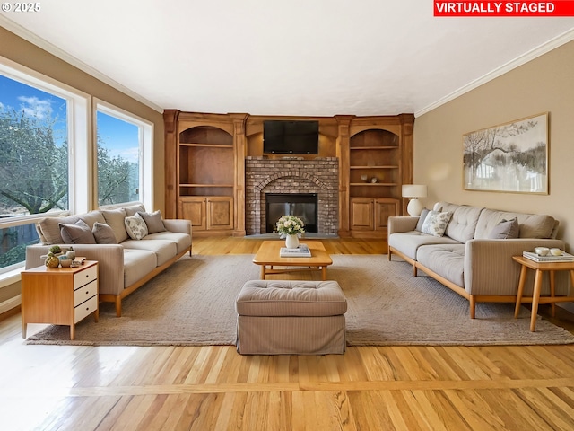 living area featuring a fireplace, crown molding, and wood finished floors