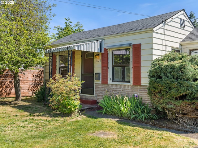 3128 SE 64th Ave, Portland, OR 97206 - bungalow-style home with roof with shingles, a front yard, and brick siding