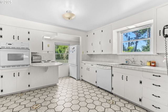 15170 SE 202nd Ave, Damascus, OR 97089 - kitchen featuring white appliances, decorative backsplash, white cabinetry, and light flooring