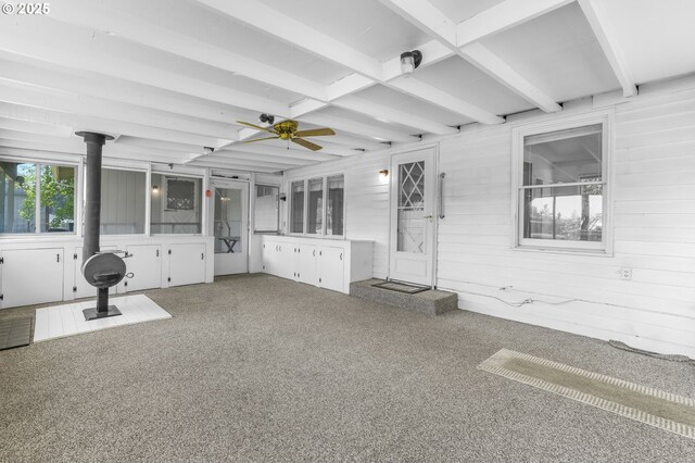 15170 SE 202nd Ave, Damascus, OR 97089 - unfurnished sunroom with a wood stove, ceiling fan, and beam ceiling