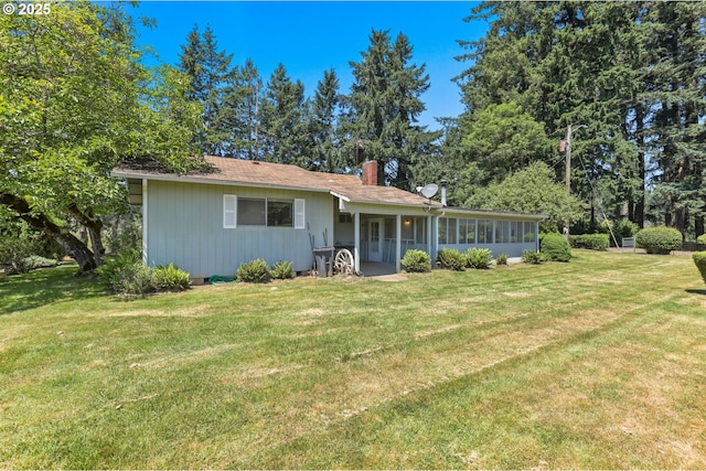 15170 SE 202nd Ave, Damascus, OR 97089 - view of front of home with a chimney, a front yard, and a sunroom