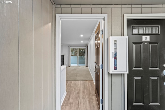 hallway with light hardwood / wood-style floors