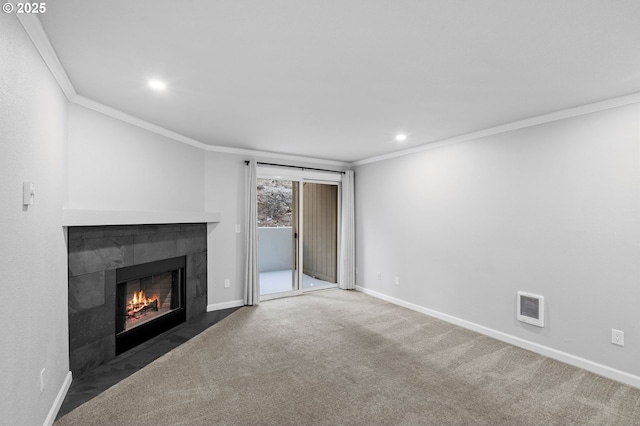 unfurnished living room featuring ornamental molding, dark carpet, and a tile fireplace