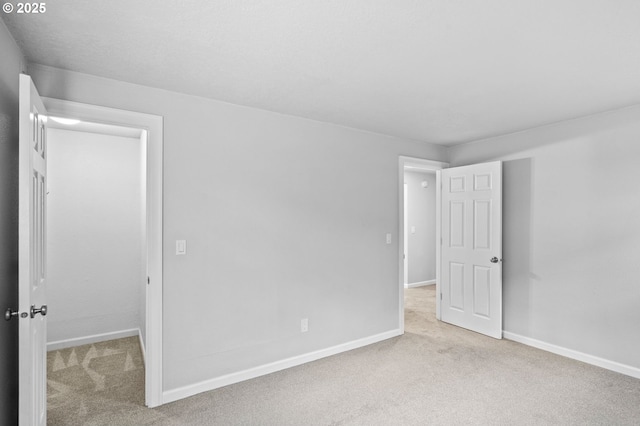 empty room featuring light colored carpet