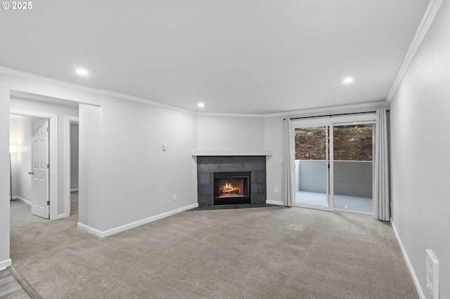 unfurnished living room with ornamental molding, light carpet, and a tile fireplace