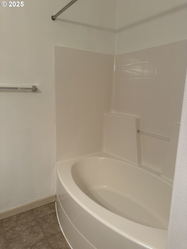 bathroom with tile patterned floors and shower / tub combination