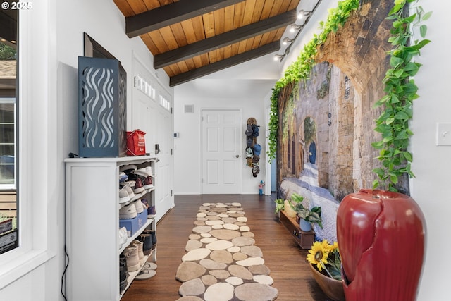 foyer entrance with wood ceiling, dark wood-type flooring, and vaulted ceiling with beams