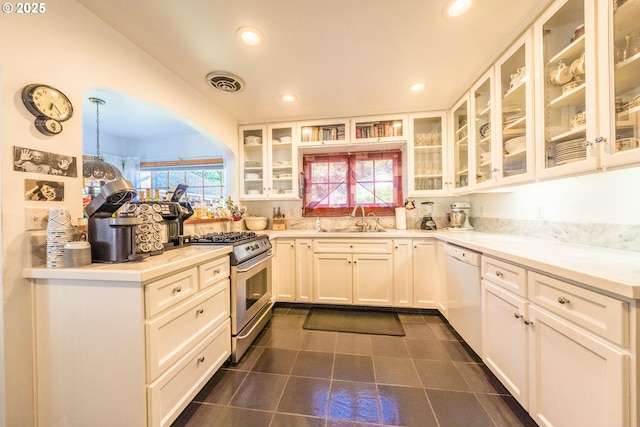 1756 NW 35th Pl, Lincoln City, OR 97367 - kitchen with stainless steel gas range, dishwasher, recessed lighting, white cabinetry, and glass insert cabinets