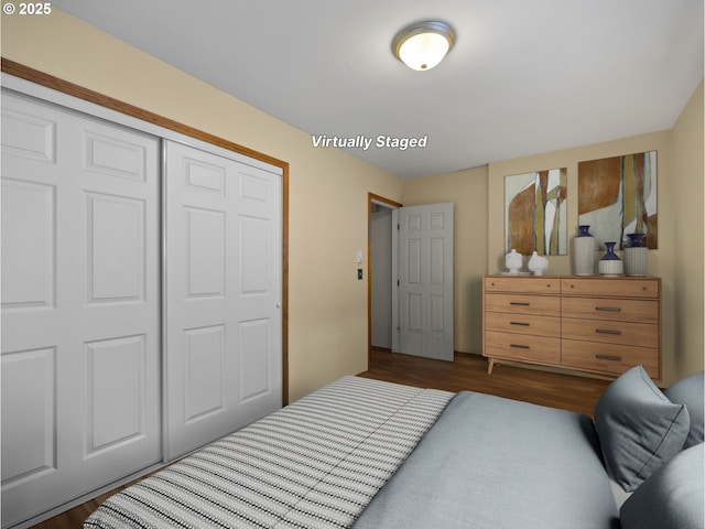 bedroom featuring dark hardwood / wood-style flooring and a closet