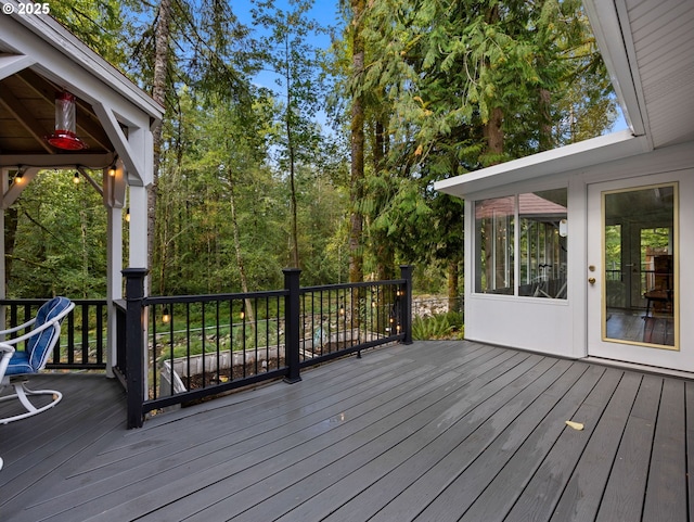 wooden deck with a sunroom