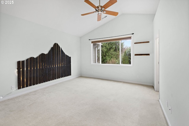 empty room with ceiling fan, light colored carpet, and lofted ceiling