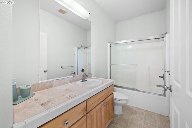 full bathroom with toilet, enclosed tub / shower combo, and vanity