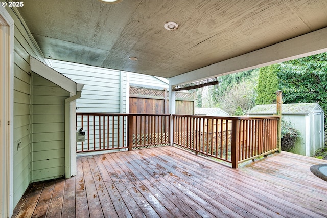 wooden deck with a storage shed