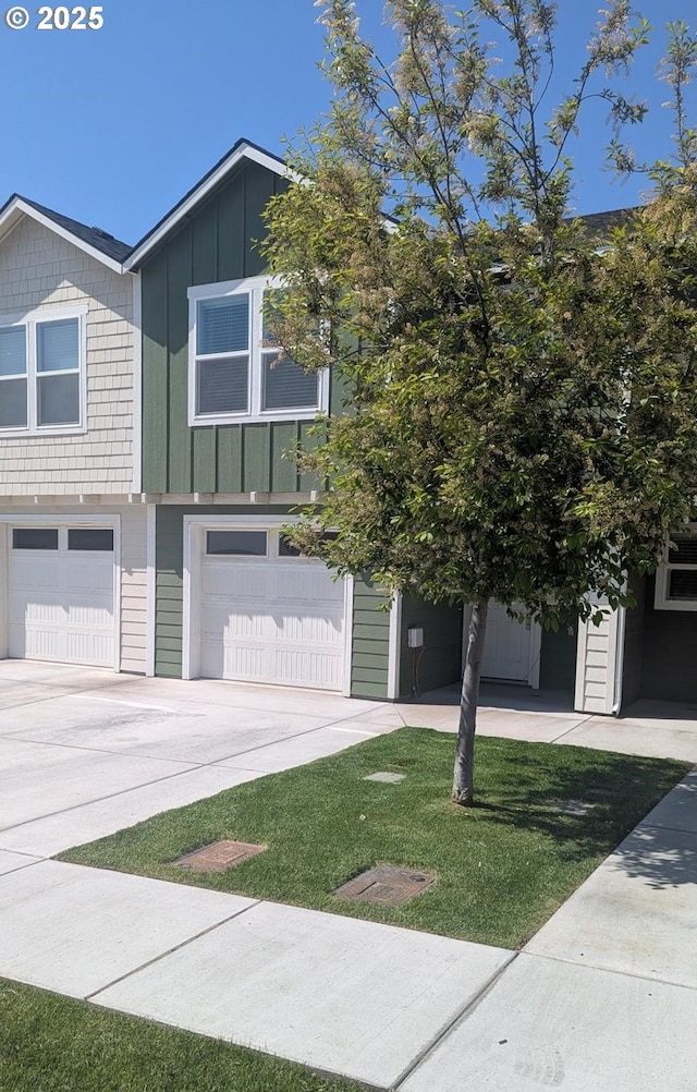 1745 NE 8th St, Hermiston, OR 97838 - view of front of home with board and batten siding, an attached garage, and driveway