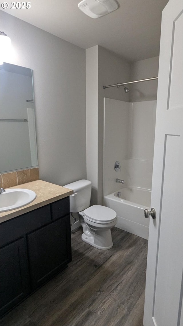 1745 NE 8th St, Hermiston, OR 97838 - bathroom featuring toilet, shower / washtub combination, wood finished floors, and vanity