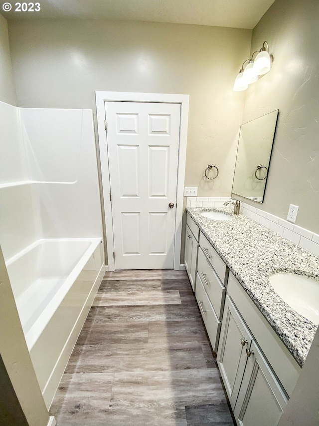 585 Baker St, Baker City, OR 97814 - full bathroom featuring double vanity and wood finished floors