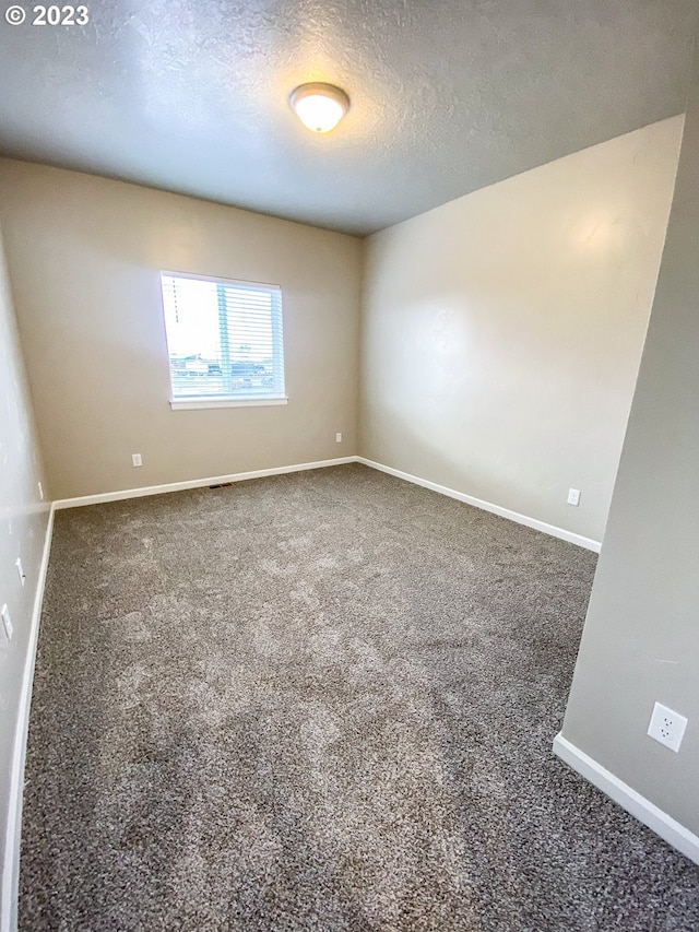 585 Baker St, Baker City, OR 97814 - empty room with carpet flooring and a textured ceiling