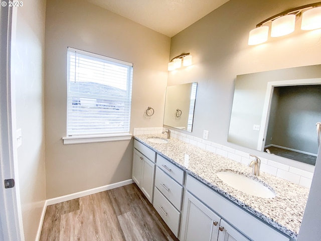 585 Baker St, Baker City, OR 97814 - full bath featuring wood finished floors, double vanity, and decorative backsplash