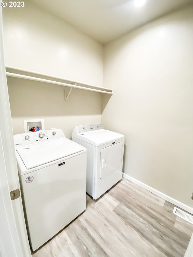 585 Baker St, Baker City, OR 97814 - laundry room with washing machine and dryer and light wood-style floors