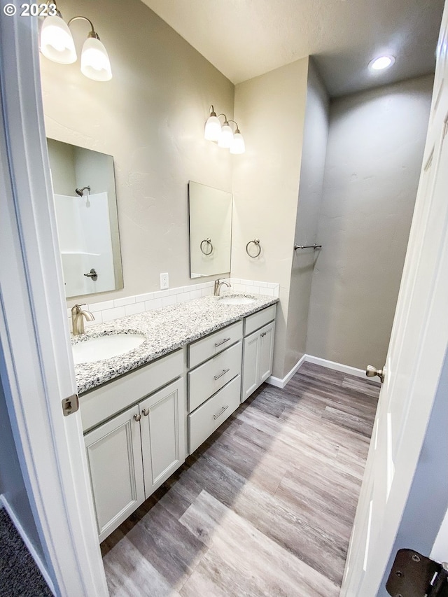 585 Baker St, Baker City, OR 97814 - bathroom featuring double vanity and wood finished floors