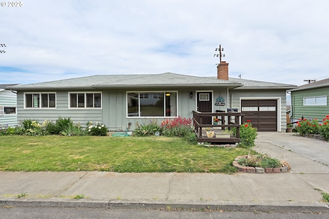 1831 E 14th St, The Dalles, OR 97058 - ranch-style house featuring an attached garage, board and batten siding, concrete driveway, a chimney, and a front yard