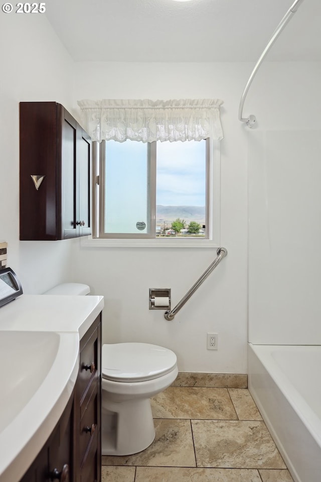 1831 E 14th St, The Dalles, OR 97058 - full bath featuring vanity, toilet, shower / bathtub combination, and baseboards