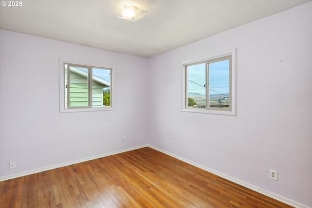 1831 E 14th St, The Dalles, OR 97058 - spare room featuring plenty of natural light, baseboards, and hardwood / wood-style floors
