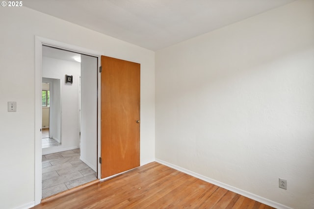 1831 E 14th St, The Dalles, OR 97058 - unfurnished bedroom with baseboards and light wood-style flooring